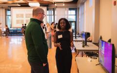Student talking to staff member in convention center