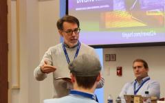 Professor speaking to group of adults in a classroom