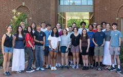 The first cohort of Democracy Scholars poses for a group photo outside Cedar Hall.