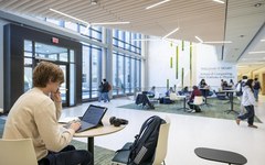 A student works on a laptop in a bright, modern study space in Integrated Science Center 4.