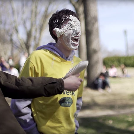 Smiling student with whipped cream on his face during Pi Day celebrations on campus