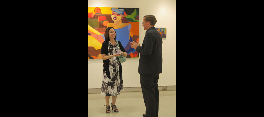 Gallery Senior Show "Color Safari", Prof. Lee and Noah Woodruff's mother in front of Noah's paintings