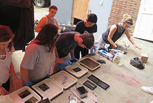 Visiting photographer, Lisa Elmaleh, and students developing images during her "Tintype Workshop", fall 2018 