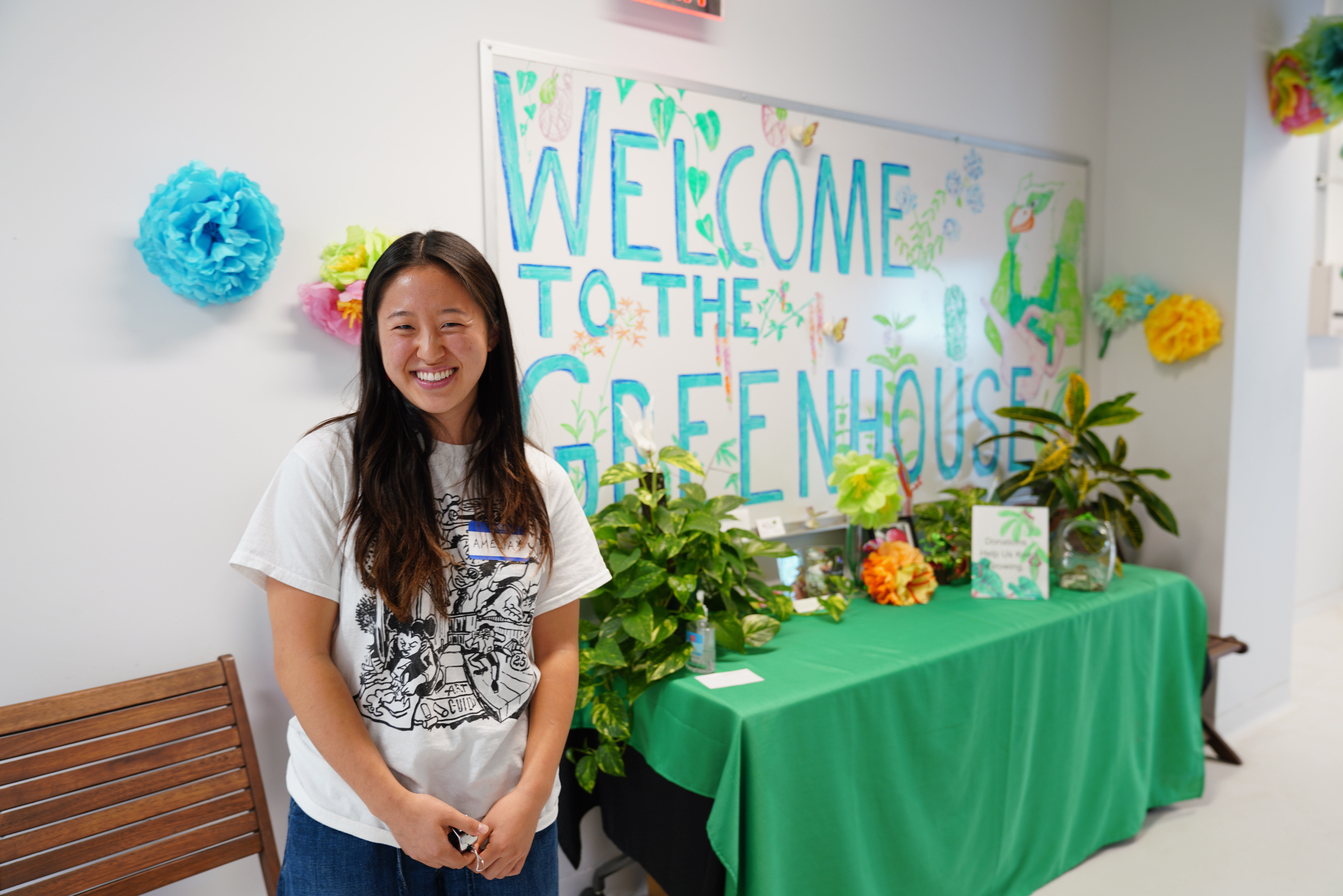 person standing in greenhouse corridor