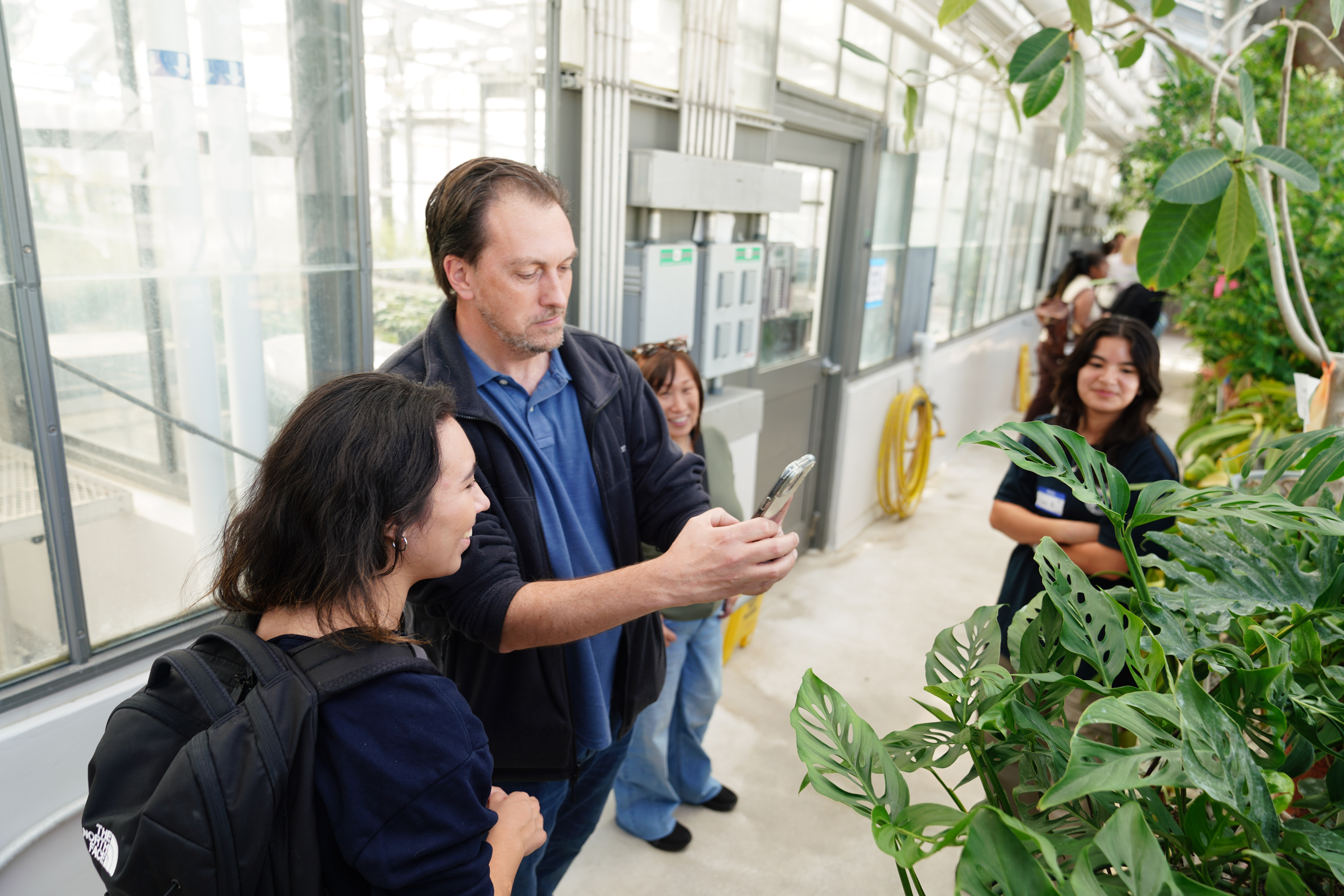 people taking photos of plants