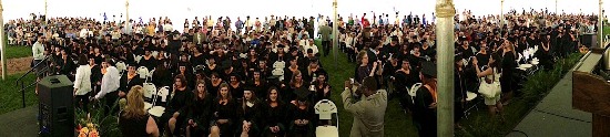 Biology majors prepare for graduation under the tent in the sunken garden