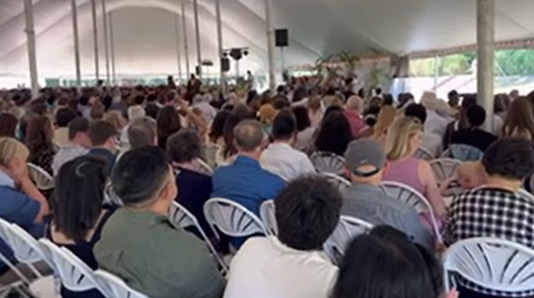 graduates and families gathered under a tent in the sunken garden for the 2026 biology grduation