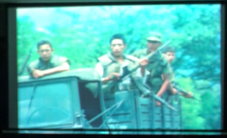 Slide 3: A group of soldiers with weapons on the back of a truck.
