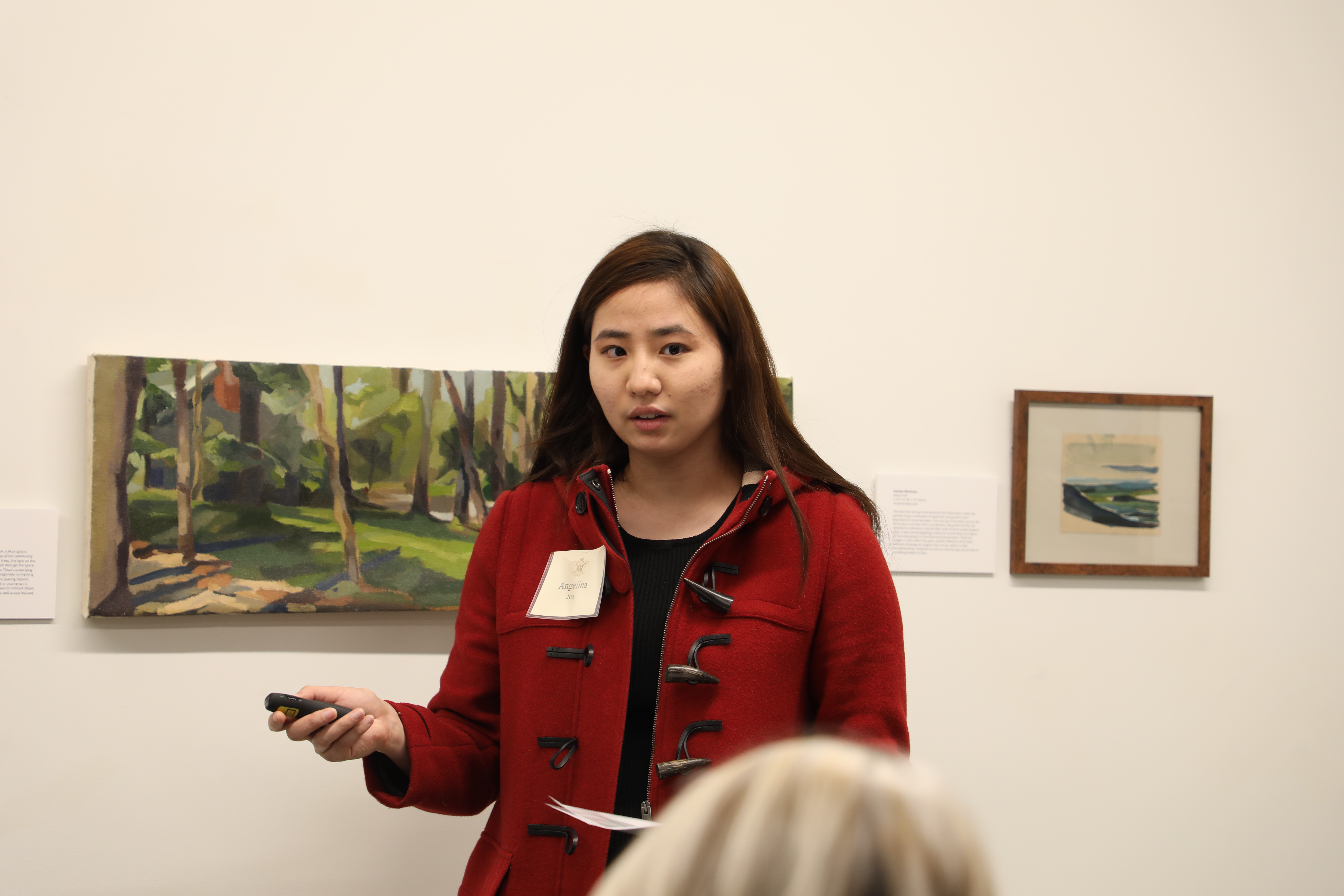 Senior Angelina Joa, an English major, shares lessons from a "Fundamentals of color and lighting" course she took through the Concept Design Academy with Catron reception attendees Nov. 13 in Sadler Center's Hart Gallery. (Photo by Adeline Steel)