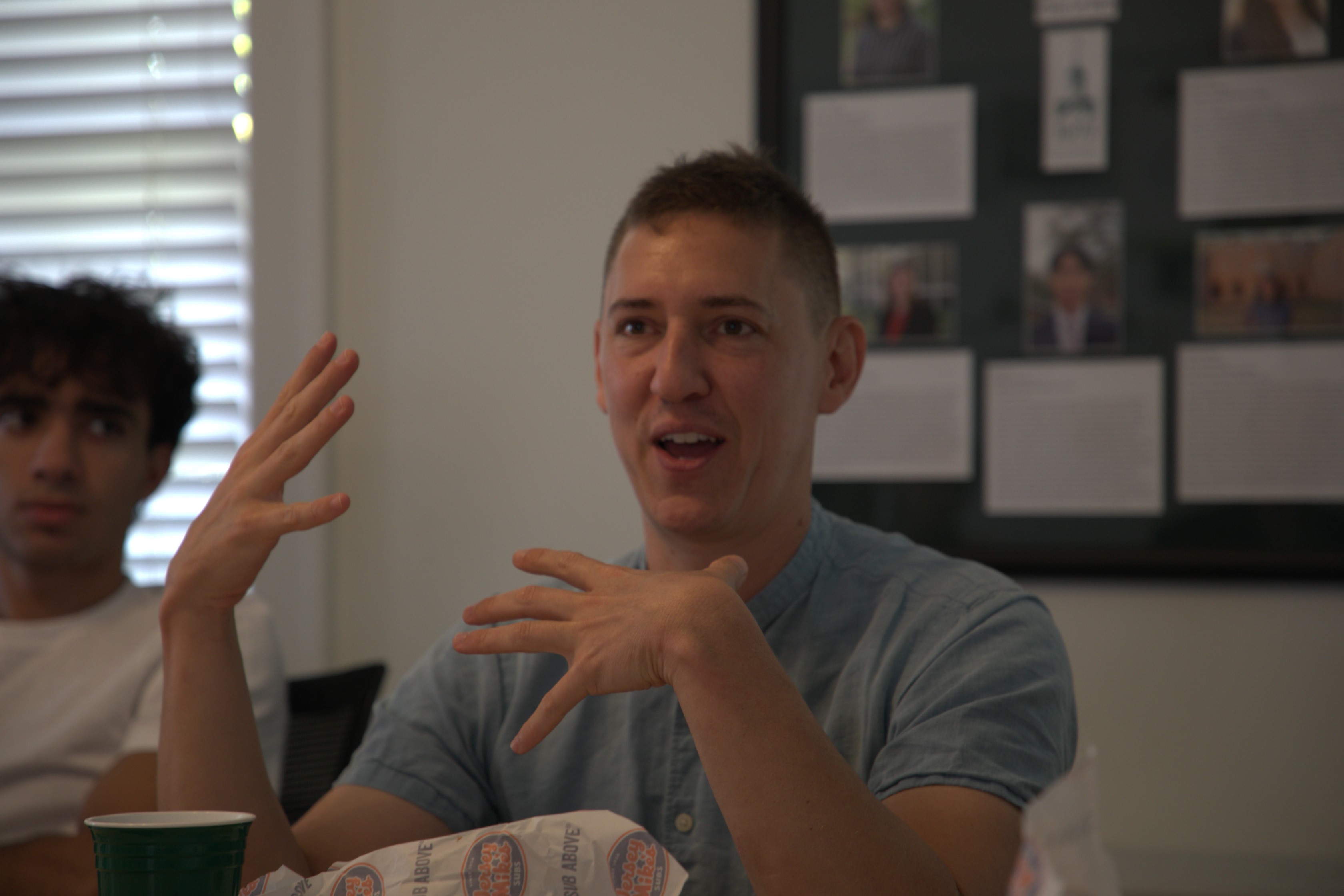 Benji Jones, senior environmental correspondent for Vox and Pulitzer Center grantee, discusses his reporting methods with 1693 Scholars in Murray House Sept. 8. (Photo by Adeline Steel)