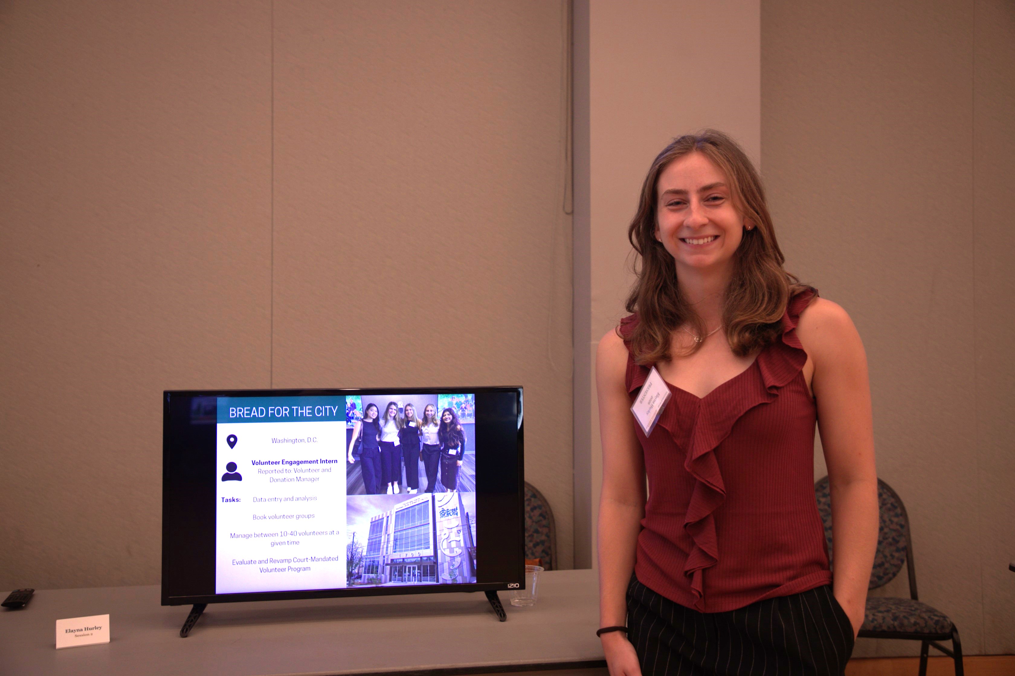 Elayna Hurley '26, one of dozens to receive support through the Office of Career Development & Professional Engagement's Funding for Unpaid and Underfunded Student Experiences (FUSE) program, presents on the impact of her experience at the annual Fall Internship & Applied Learning Showcase Aug. 29 in Sadler Center. (Photo by Adeline Steel)