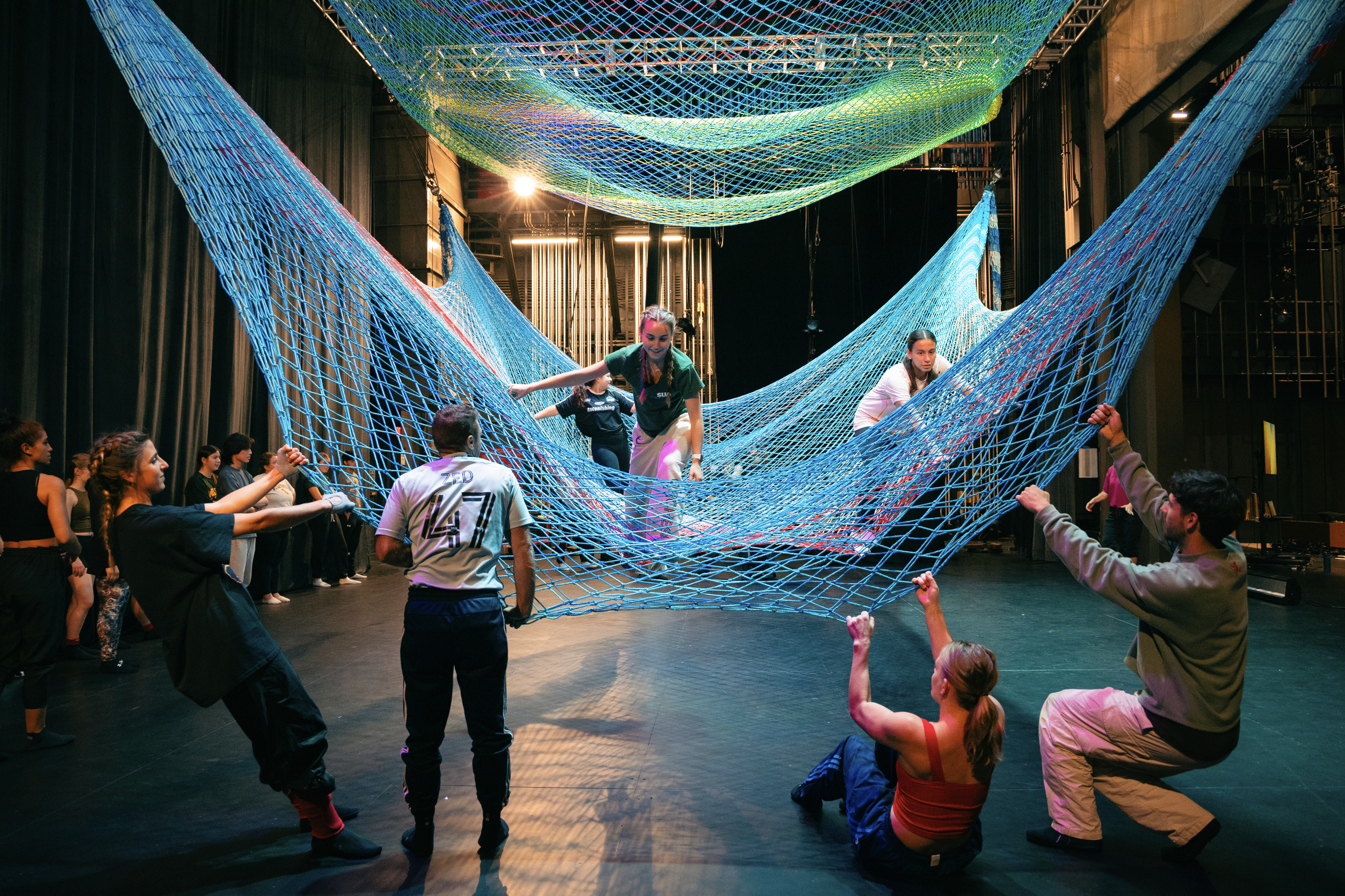 Students of Leah Glenn, William R. Kenan, Jr. Professor of Dance, move across one of the two nets comprising Noli Timere's living sculpture. (Photo by Samuel Li)