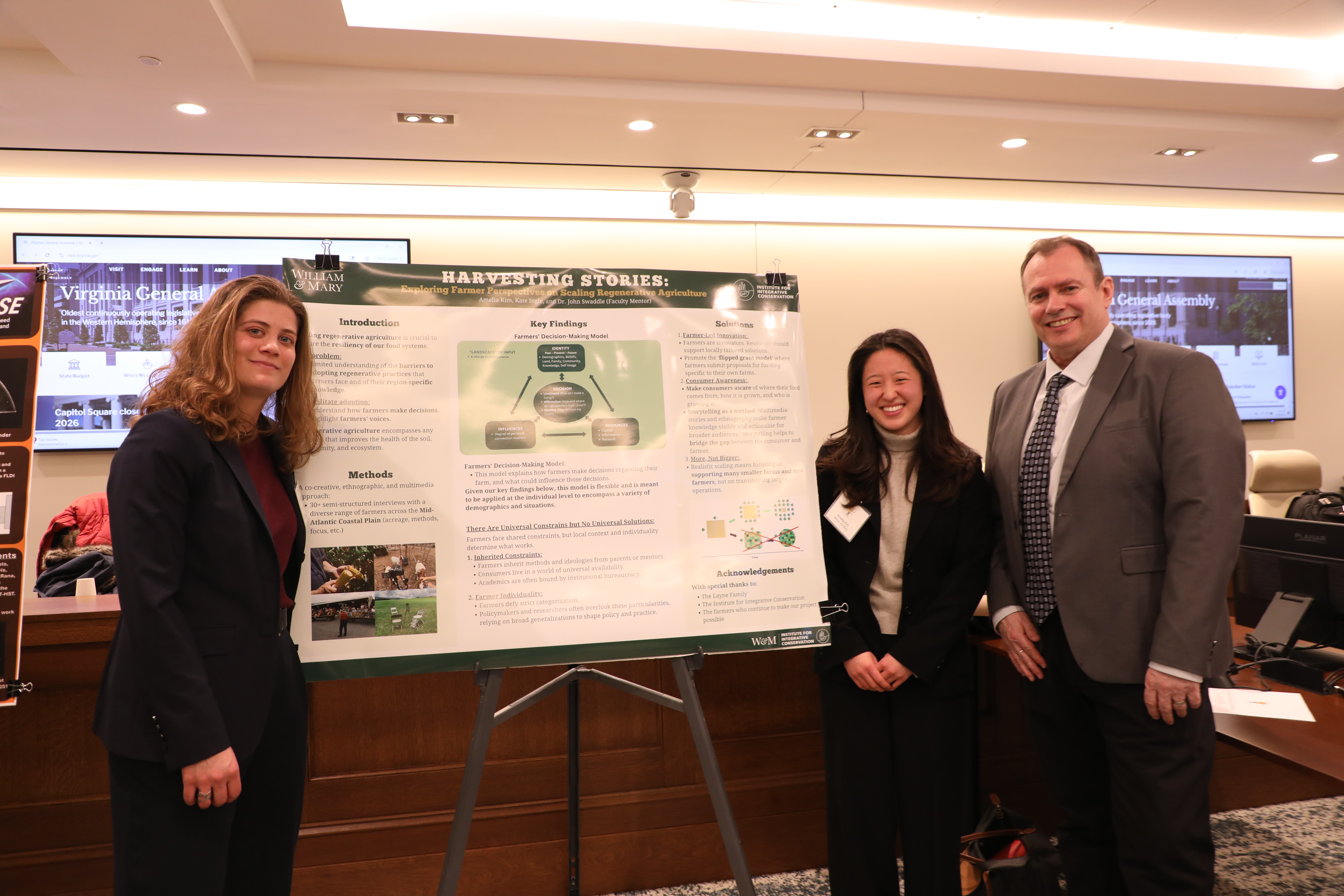 Kate Ingle ’27, an integrative conservation and anthropology double major, and Amelia Kim ’27, an integrative conservation and art history/built environment studies double major, join John Swaddle, faculty director of the Institute for Integrative Conservation and professor of biology (left to right), at the Network for Undergraduate Research in Virginia showcase at the State Capitol Jan. 29. (Photo by Adeline Steel)