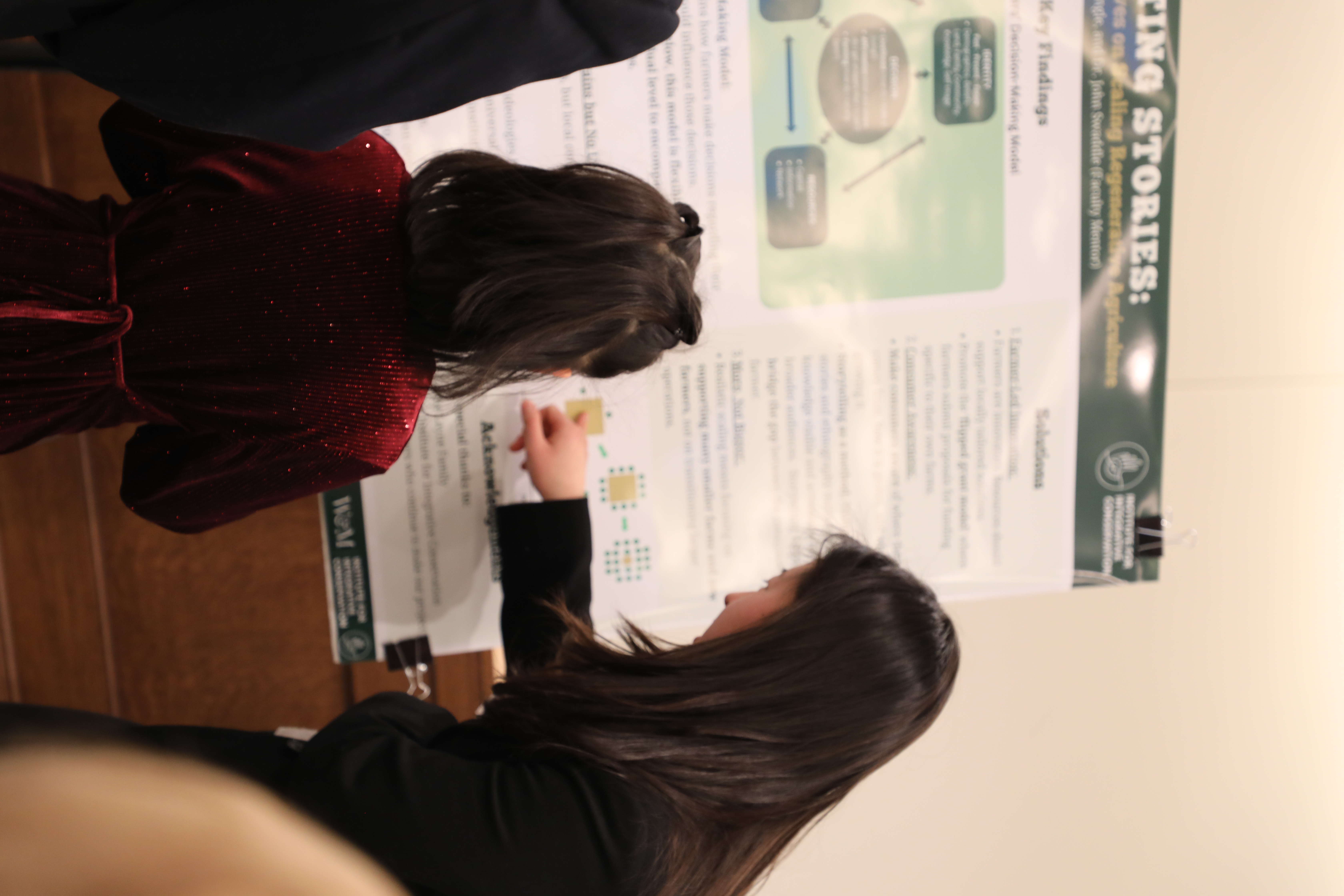 Amelia Kim '27 explains findings from the Institute for Integrative Conservation's Conservation Research Program to children who were among the dozens of attendees at the Network for Undergraduate Research in Virginia showcase at the Virginia State Capitol Jan. 29. (Photo by Adeline Steel)