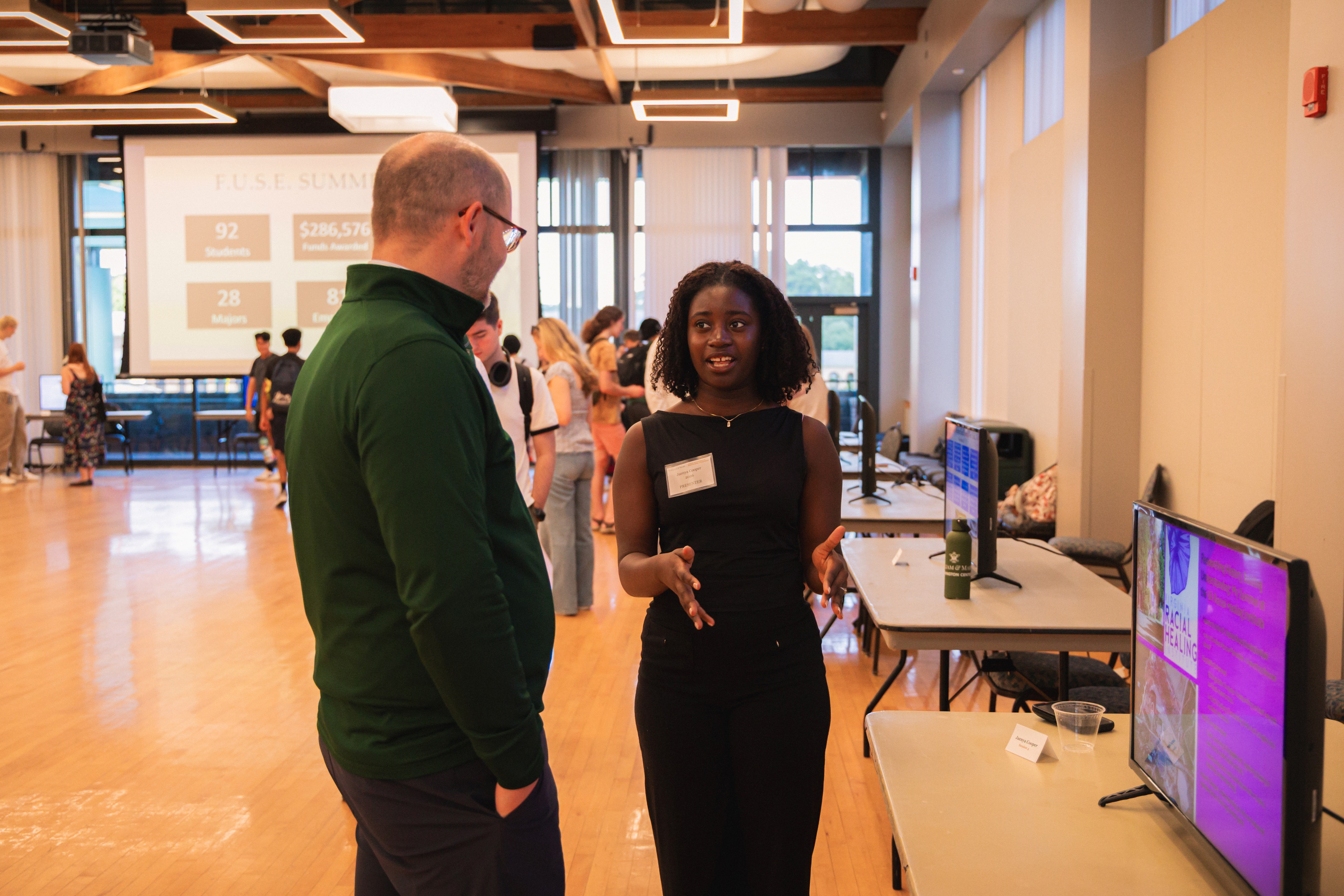 Jaenya Cooper '26 discusses her Charles Center City Research Scholars internship with Dr. Phil Heavilin, director of internships & applied learning in the Office of Career Development & Professional Engagement Aug. 29 in Sadler Center. (Photo by Samuel Li)