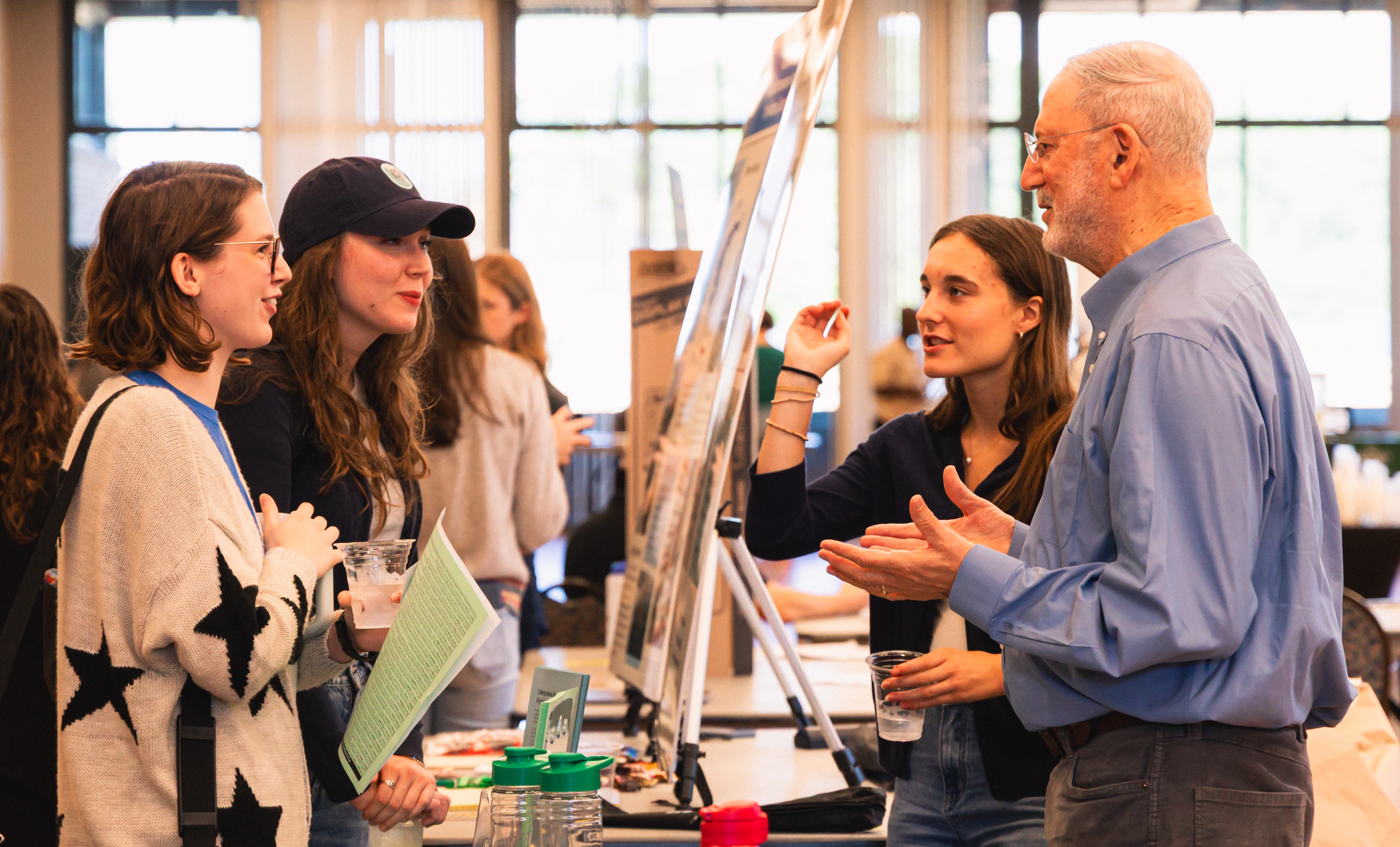 Psychology and data science double major Ela Sobol '27 and Professor of Psychology Harvey Langholtz (right) discuss undergraduate research opportunities in Sadler Center's Chesapeake Room Oct. 15. (Photo by Samuel Li)