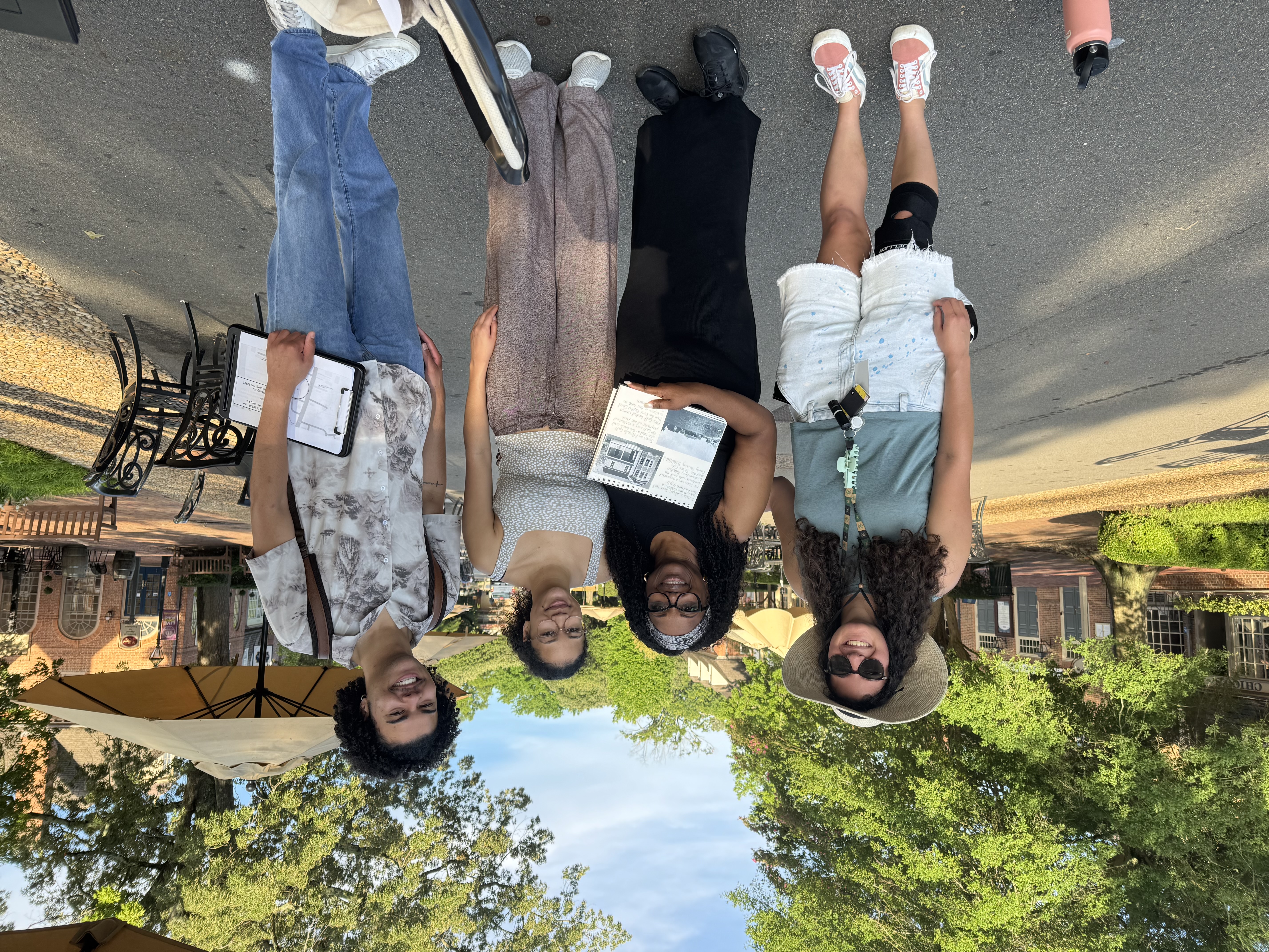 Terrence McDuffie '26 (far right) works alongside campus and community members during his City Research Scholars internship with The Village Initiative last summer. (Courtesy photo)