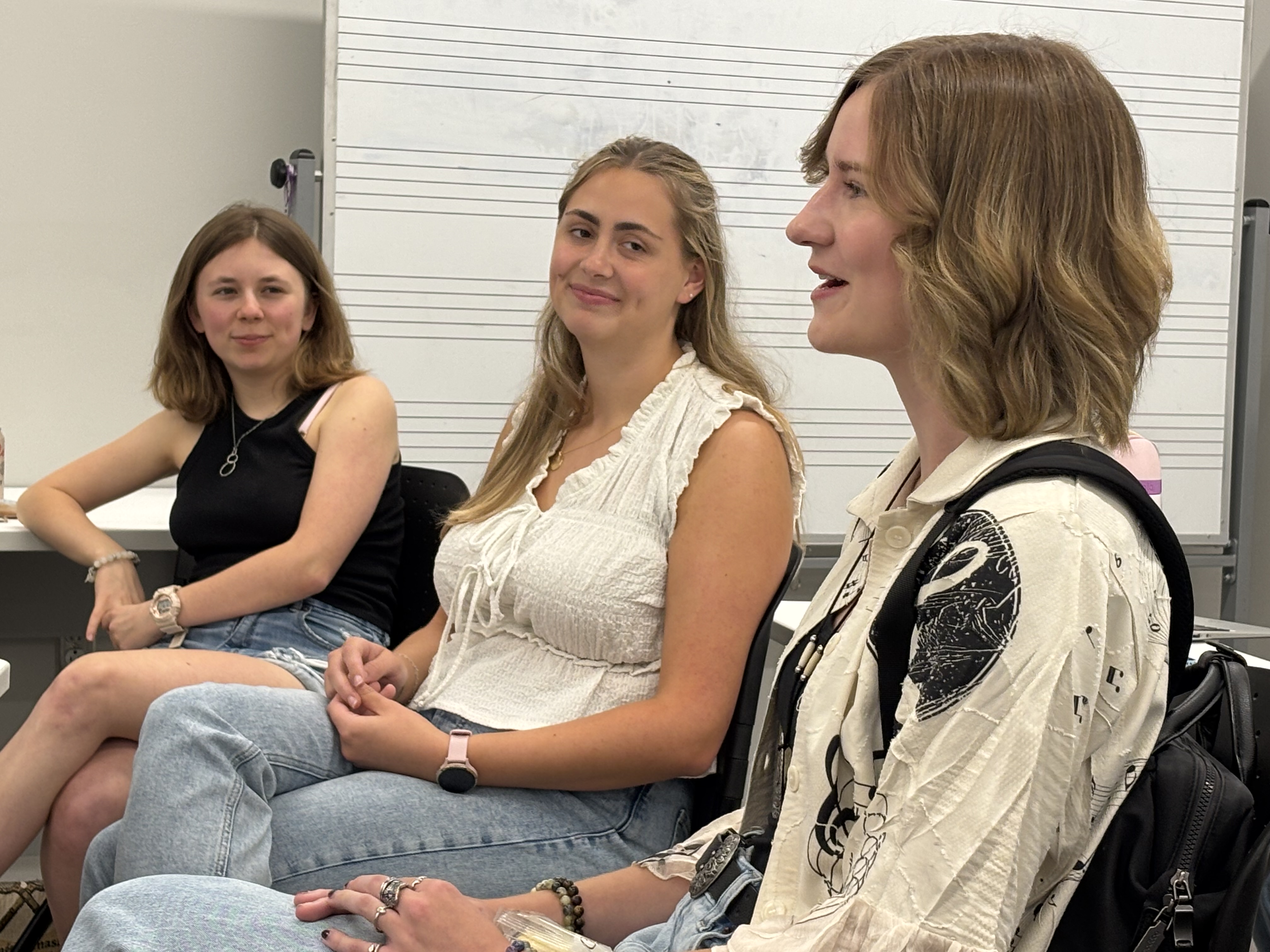 Natasha Haines '27, Caroline Pence '26, and Sarah Schulte '26 (left to right) discuss the impact of the Woody Internship in Early Childhood Music Education on their academic journies and professional goals during a masterclass held in William & Mary's Music Arts Center last September. (Photo by Ted Maris-Wolf)