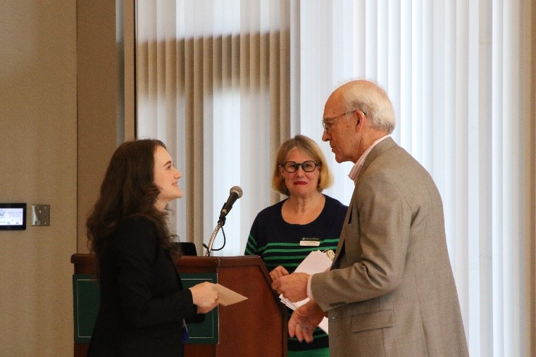 Government and anthropology double-major Erin Cearlock '24 (left) received the inaugural Barr Prize for public speaking from Stanley "Butch" Barr '62 (right) at the Charles Center's "Thesis in Three" event as a part of the Graduate & Honors Research Symposium March 22 in Sadler. (Photo by Emmanuel Sampson)