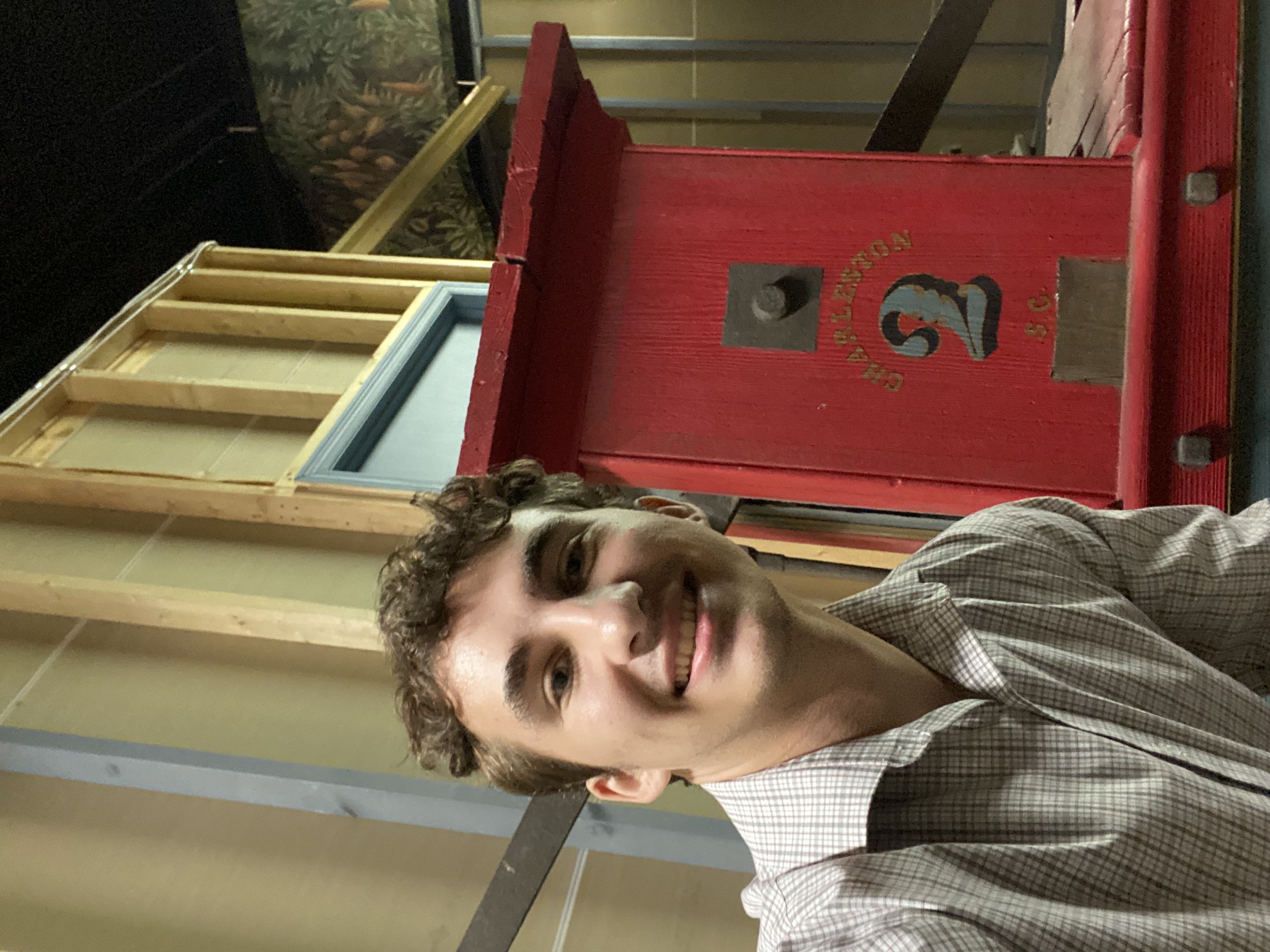 Art history major William Armacost '26 is delving into Charleston Museum archives this summer to better understand the history of a 19th-century fire pump cart made by enslaved craftspeople. (Courtesy photo)