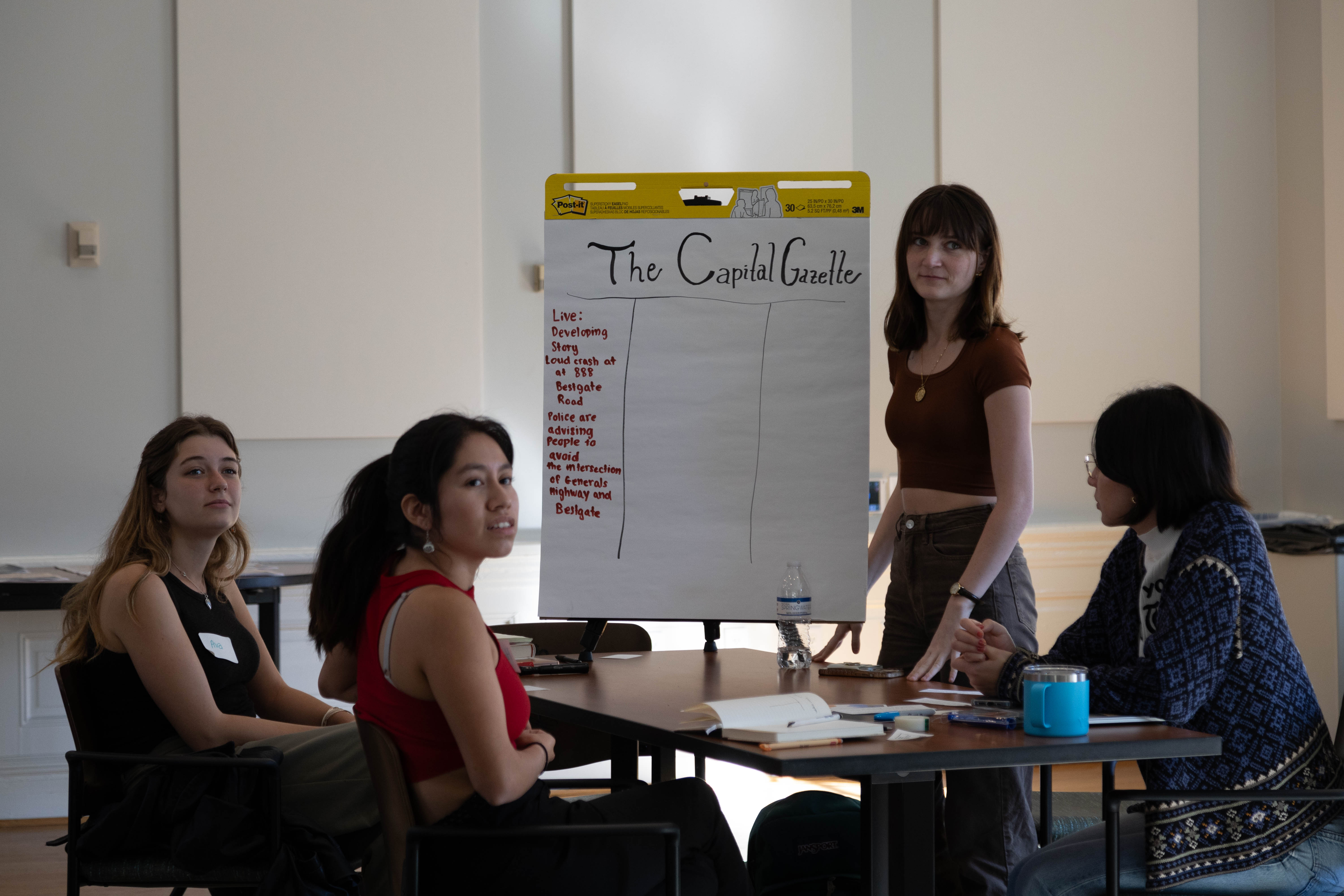Ava Echard '25, Haidyn Brockelman '26, Logan Mischke '26, and Alex Nakamitsu '26 (left to right) collaborate in a newsroom simulation in Denise Watson's masterclass last October in the Grimsley Boardroom. (Photo by Tess Willett)