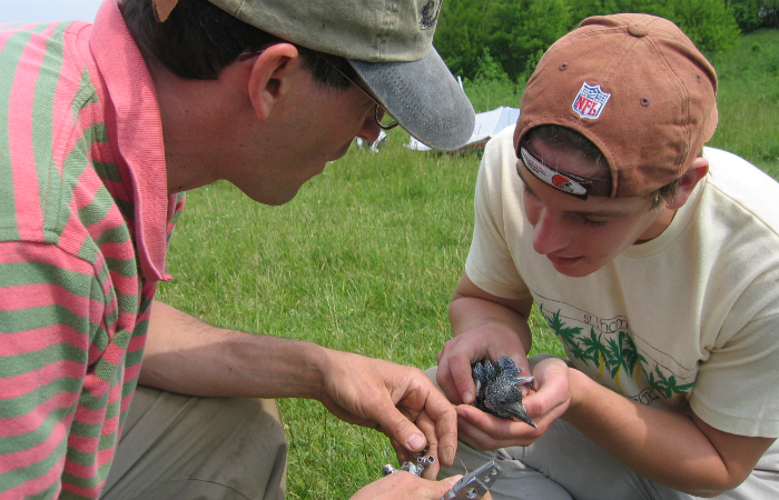 Researchers Holding Bird