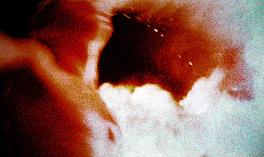 A photograph of a movie scene depicting a man breathing fire