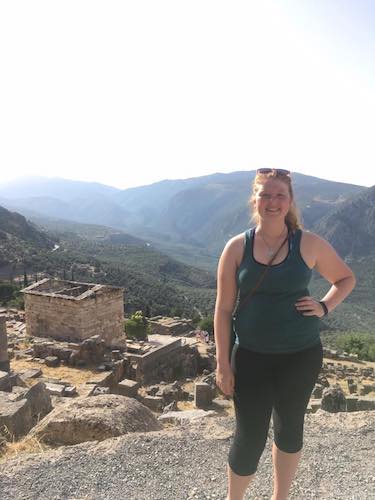 Kathleen at Delphi with the amazing view and the Athenian Treasury (seen from above)