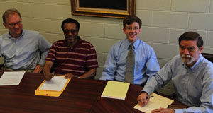 Economics professors Till Schreiber, Berhanu Abegaz, Peter McHenry, and Robert Archibald working out the redesigned class details