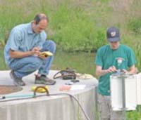 Geology Professor Greg Hancock, assisted by student Marshall Popkin, collects GIS data