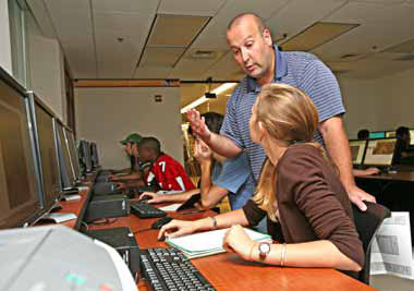 Professor Hamilton works with students in the GIS lab.