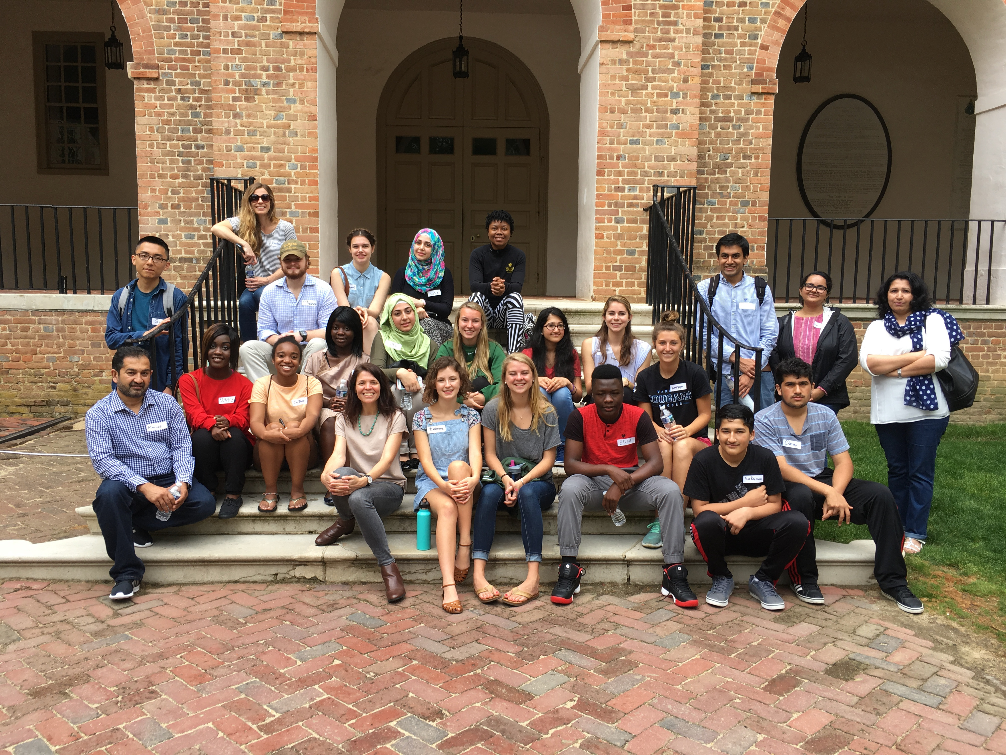 A Holistic Look at Migration: Professor Andrea Wright (front row, center-left) and students in her COLL 150 course "Migration and Culture" hosted college-age visitors who had come to the United States as refugees. She says, "Having read about refugees in class, students were able to extend their learning out of the classroom and hear first-hand about how individuals experience the process of moving to the United States as a refugee."