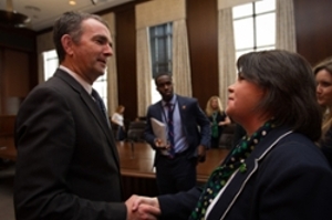 Opoku-Yeboah stands behind Governor Northam while he meets with the Girl Scouts of America Organization. Photo Courtesy of Governor Ralph Northam
