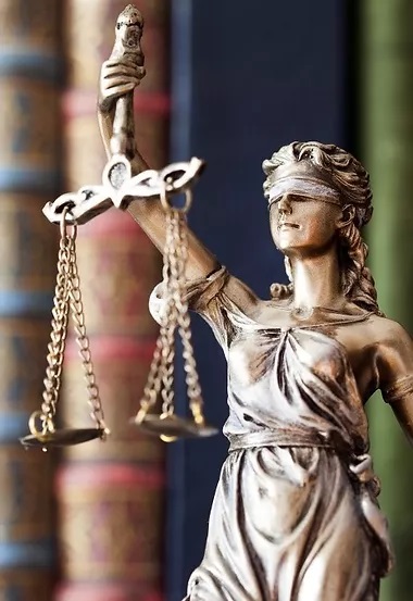 Image of a bronze statue of the scales of justice