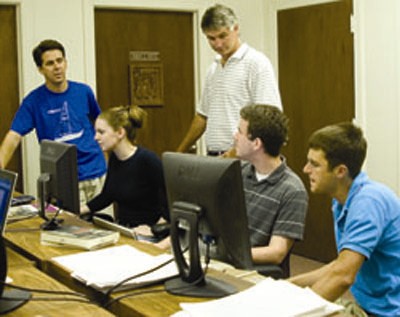 Rob Hicks, Mike Tierney (standing) discuss adding sectors to the data base with Charlotte Jackson '07, Brad Potter '08 and Scott parks '09. Parks is the brother of Brad Parks whose honors thesis became the impetus for PLAID.