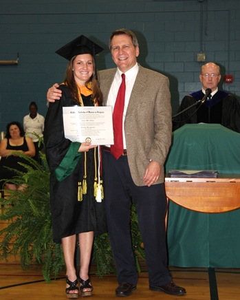 Taylor Hodge receiving diploma from Michael Deschenes