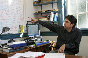 Jack Martin points to a list of word sounds in various languages he is studying. Photo by David Williard.