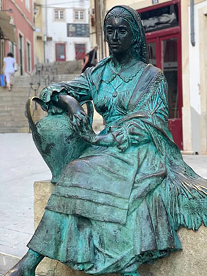 Statue of a female water carrier in Coimbra, Portugal