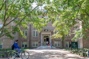 Washington Hall with cyclist passing