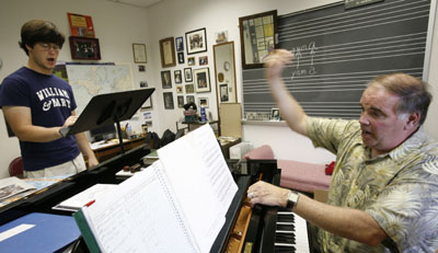 Voice instructor Ryan Fletcher with Barret Armbruster '10 at a voice lesson in Ewell Hall.