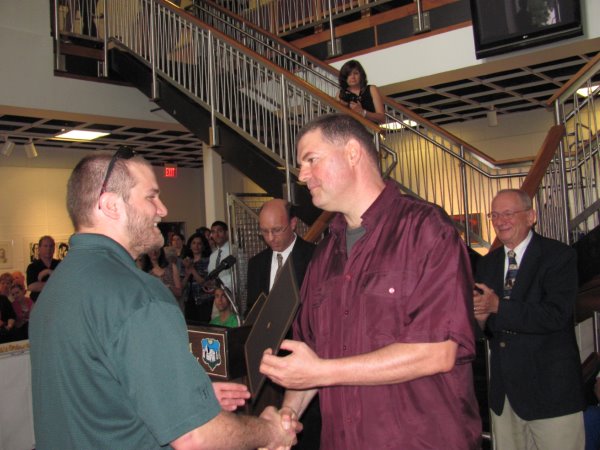 Oliver Phillips receives his Excellence in Neuroscience Award from Dr. Barnet
