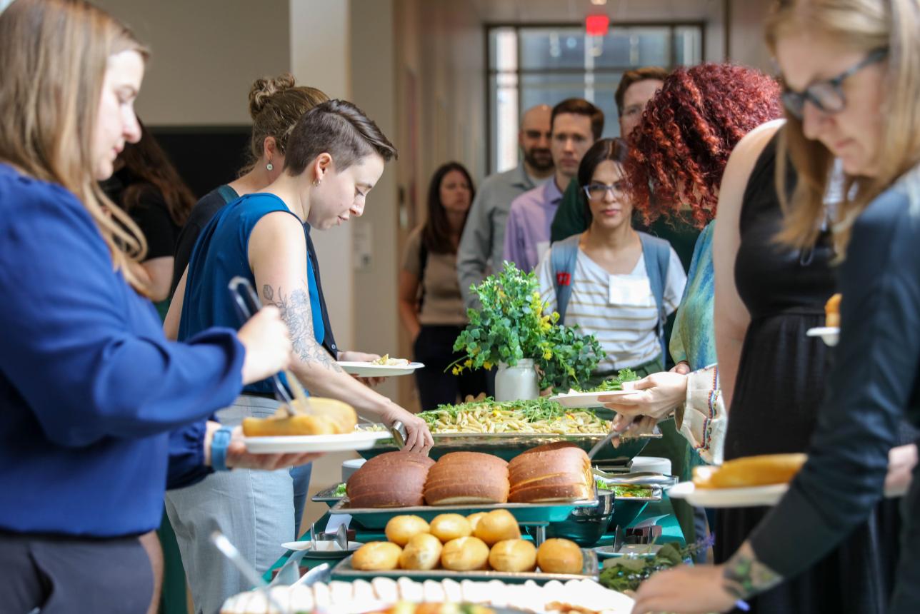 William & Mary's College of Arts & Sciences incoming faculty choose food options at a buffet table