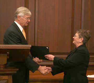 President Reveley presents Betty with a certificate honoring her years of service.