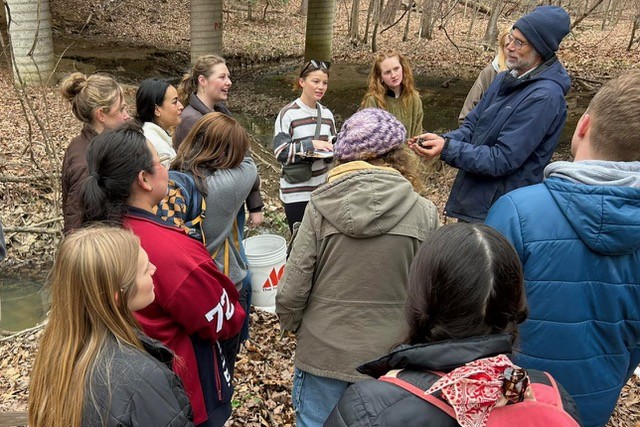 Professor Randy Chambers, director of the Keck Environmental Field Lab, gives students a hands-on demonstration.