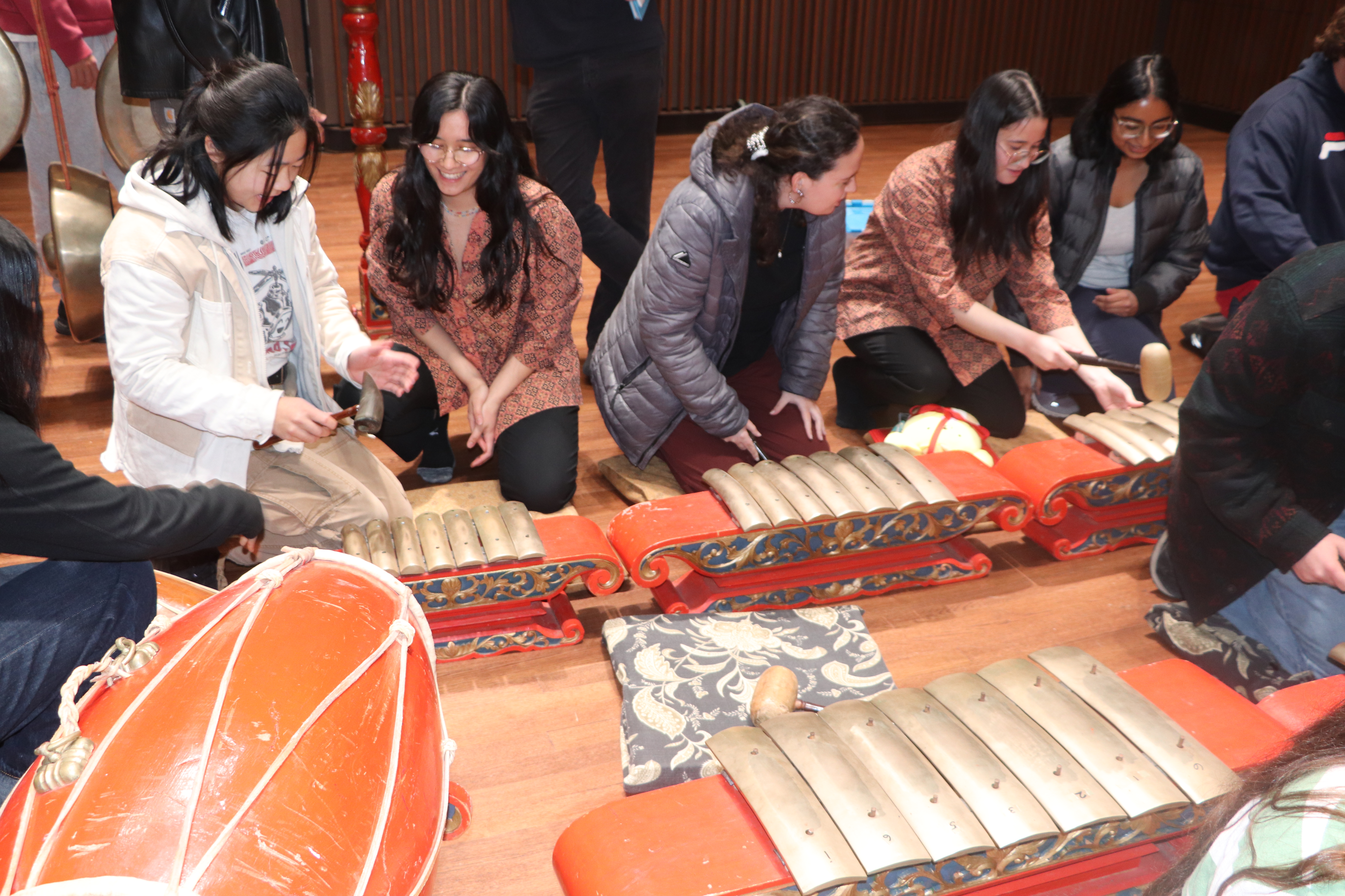 After the performance, students were invited on stage to learn more about traditional Javanese instruments from ensemble members. Photo credit: Rebecca Ries