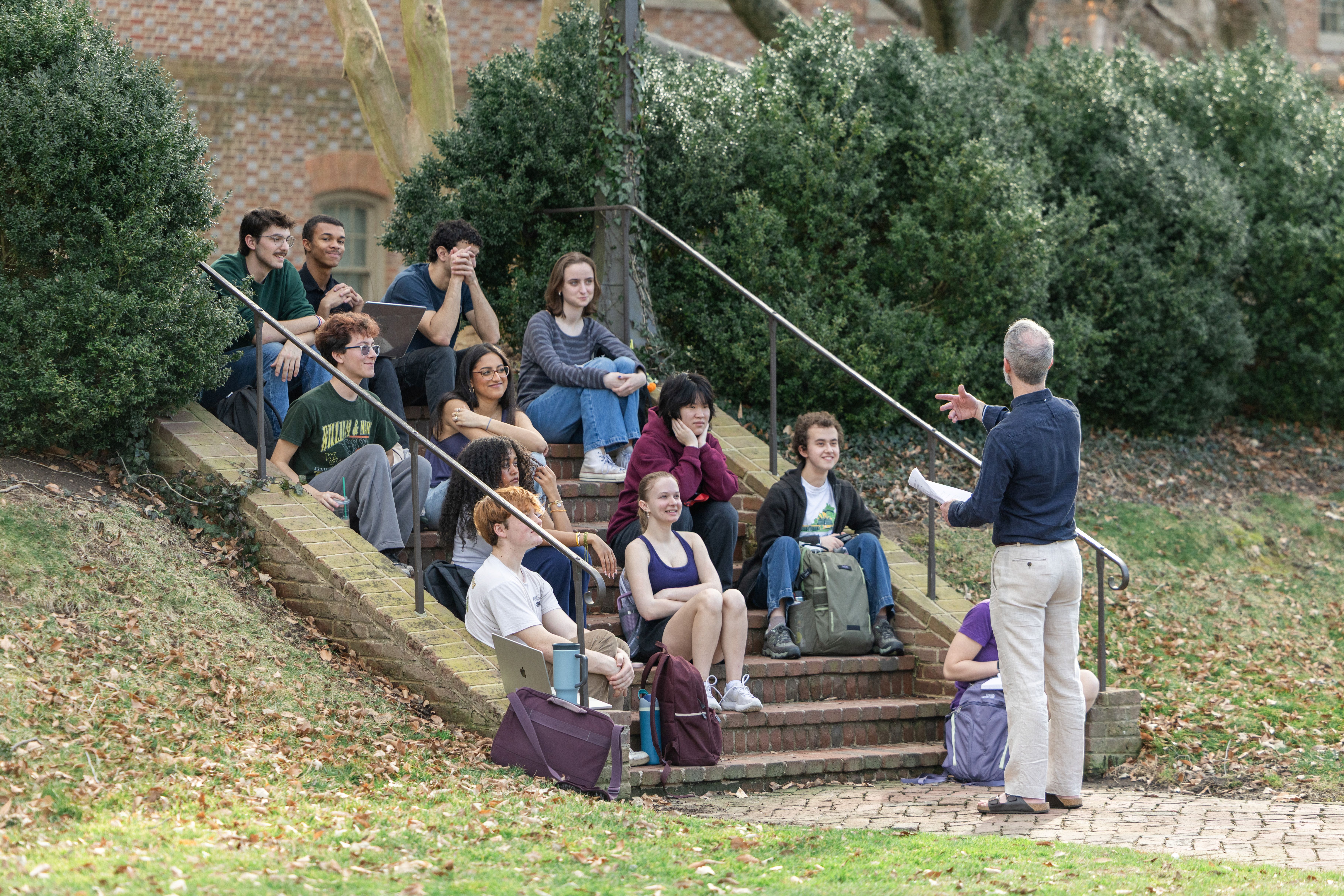 Jonah Goldwater, assistant teaching professor of philosphy, takes his students outside of the classroom to the Sunken Garden. Photo by Katie Warner.