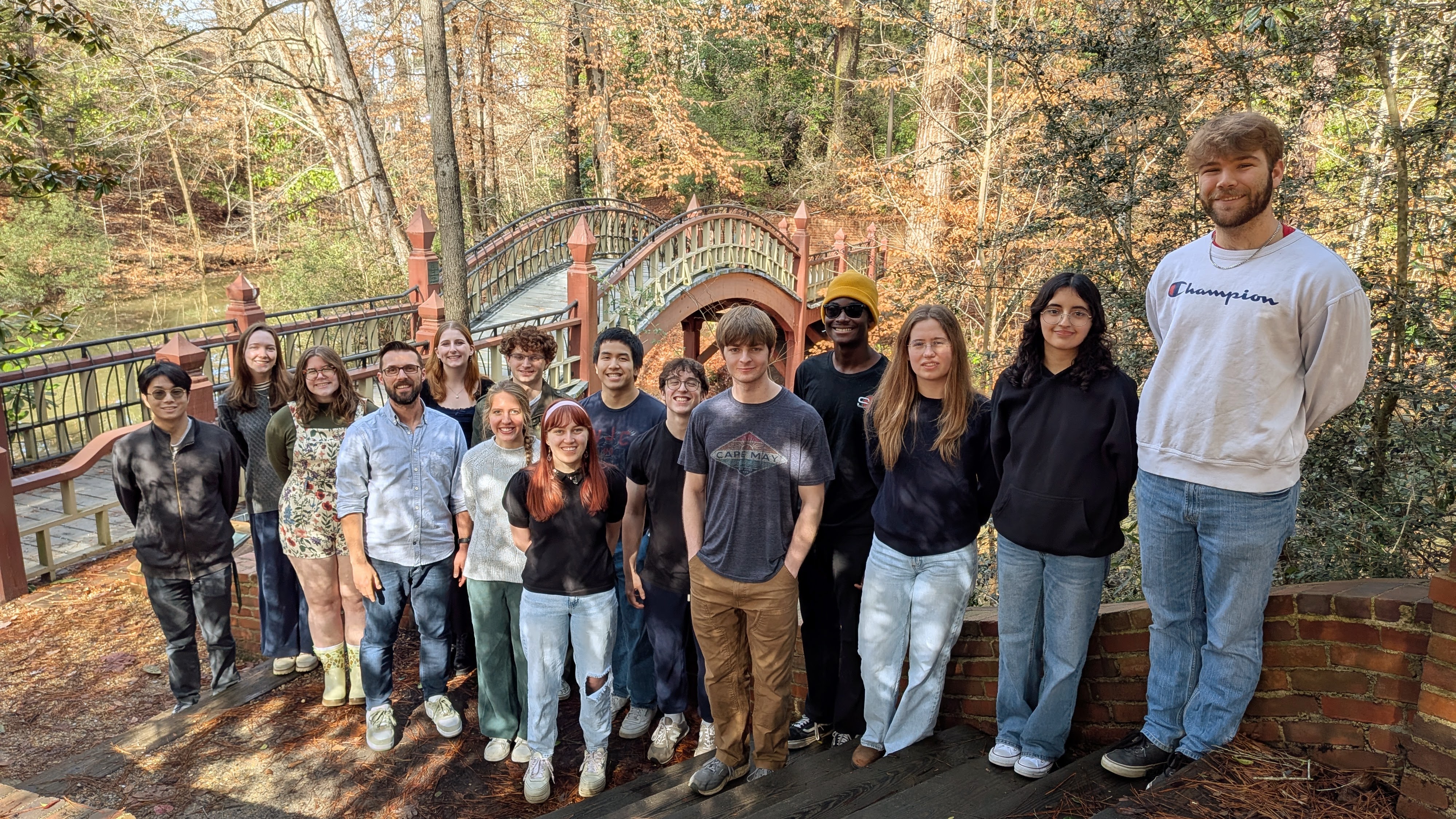 Tyler Meldrum, associate professor of chemistry, poses with his lab at the Crim Dell.