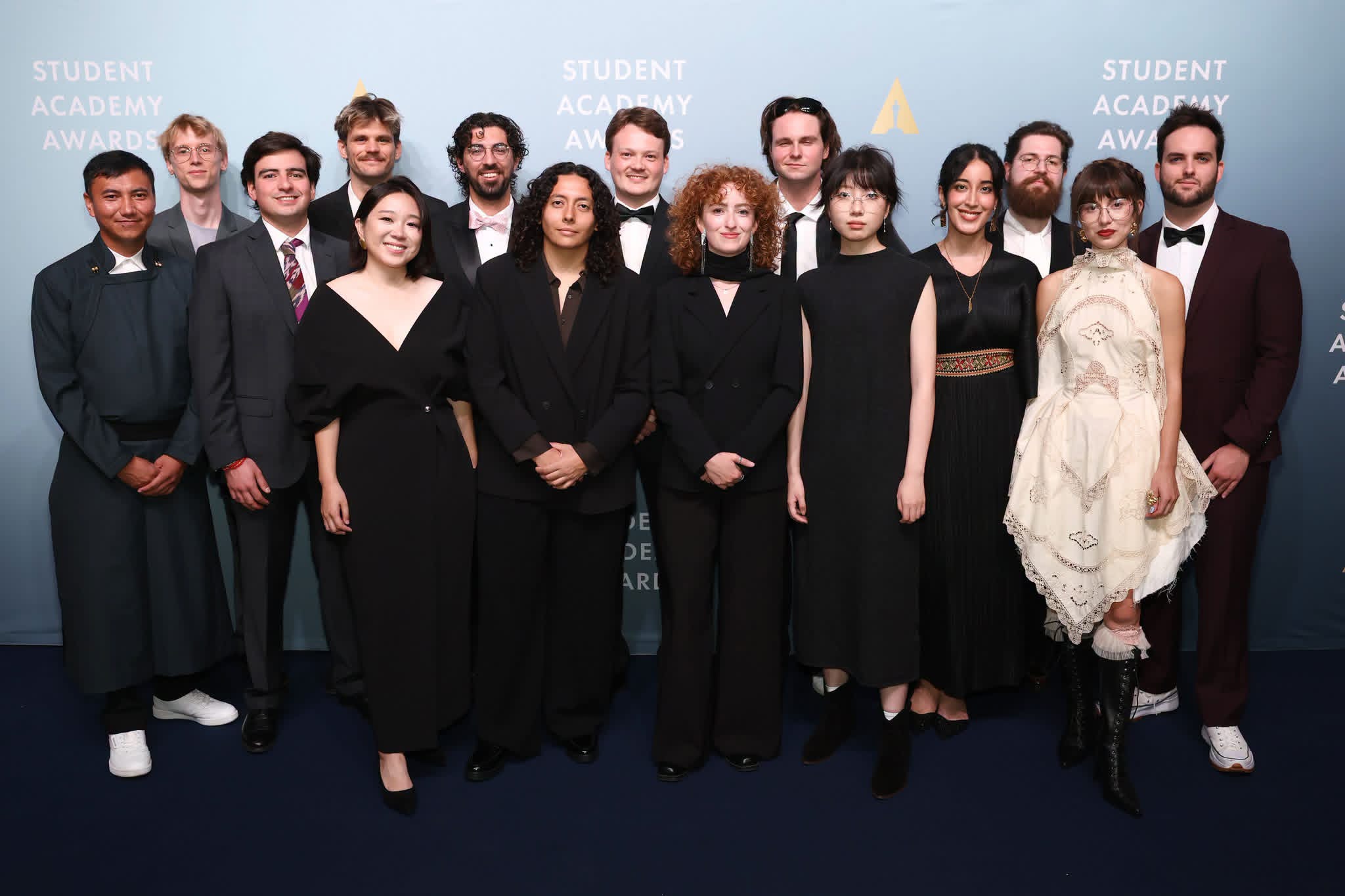 Arjun Fischer (back row, third from left) stands with the 14 other 2026 Student Academy Award winners on the award ceremony red carpet. Photo courtesy of Fischer.