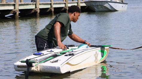 Isaiah Lemmond ’26 prepares the autonomous boat for the start of the competition