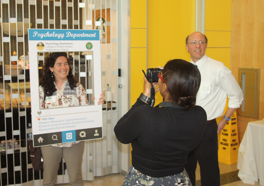 Lauren Howard takes a "selfie" of Professor Forestell while Professor Burk waits for his turn
